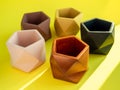 Colorful pentagon geometric concrete planters. Painted concrete pots for home decoration