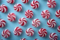 Colorful peppermint swirl jelly candies on a bright blue background