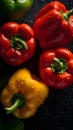 Juicy peppers - green, red, and yellow - freshly picked from the garden and covered in droplets of water.