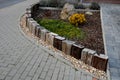 A colorful perennial flowerbed at the entrance to the garden bordered by a decorative wooden palisade. from the back it is connect