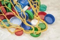 Colorful PET plastic bottle caps in mesh string bag stored for recycling, top view. Concept of recycling, ecology Royalty Free Stock Photo