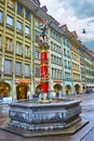 Colorful Pfeiferbrunnen fountain with sculpture of Minstrel located on Spitalgasse street, on March 31 in Bern, Switzerland