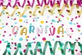 Letters of Carnival, paper streamers an confetti on white background.