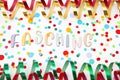 Letters saying Carnival in German, paper streamers and confetti on white background. Royalty Free Stock Photo