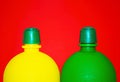 Colorful photography Red background between green and yellow small bottles Royalty Free Stock Photo