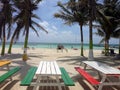 Colorful picnic tables on beach Caye Caulker