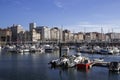 Colorful picturesque houses along the river with small boats captured in Llanes, Spain