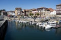 Colorful picturesque houses along the river with small boats captured in Llanes, Spain