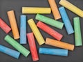 Colorful pieces of chalk on blackboard Royalty Free Stock Photo