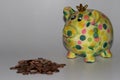 A colorful piggy bank with a steepled cent coins isolated on a white underground and background Royalty Free Stock Photo