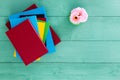 Colorful pile of books stacked on a green table