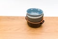 colorful piled up empty stoneware bowls on a wooden tabletop with copy space