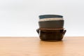 colorful piled up empty stoneware bowls on a wooden tabletop with copy space