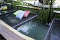 Colorful pillows on net seat among nature
