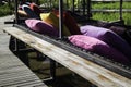 Colorful pillows on net seat among nature