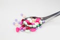 Colorful pills and capsule on spoon in white background Royalty Free Stock Photo