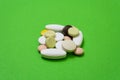 Colorful pills and capsules on a green background Royalty Free Stock Photo