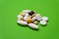 Colorful pills and capsules on a green background Royalty Free Stock Photo