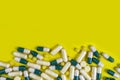 colorful pills and tablets on yellow background Royalty Free Stock Photo