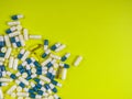 colorful pills and tablets on yellow background Royalty Free Stock Photo