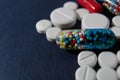 Colorful pills closeup on dark blue background