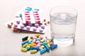 Colorful pills with glass of water Royalty Free Stock Photo