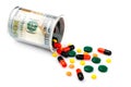 Colorful pills spilled from a bottle made of money, on white background. The Concept of Drug Purchase. The concept of Royalty Free Stock Photo