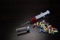 Colorful Pills, Syringe and Ampule With Liquid On Black Backgrou