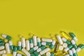 Colorful pills and tablets on yellow background Royalty Free Stock Photo