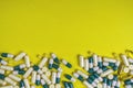 Colorful pills and tablets on yellow background Royalty Free Stock Photo