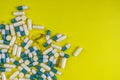 colorful pills and tablets on yellow background Royalty Free Stock Photo