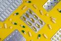 colorful pills and tablets on yellow background Royalty Free Stock Photo