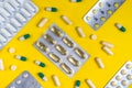colorful pills and tablets on yellow background Royalty Free Stock Photo