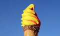 Pineapple and Raspberry Flavored Soft Serve Ice Cream Cone on Vivid Blue Sky Royalty Free Stock Photo