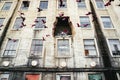 Colorful pink birds flying from a damaged building