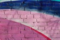 Colorful pink, blue, violet and white painted brick wall