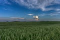 Colorful pink clouds over a wheat field at sunset Royalty Free Stock Photo