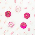 Colorful pink donuts with marshmallow on white background. Round frame, copy space. Flat lay, top view Royalty Free Stock Photo