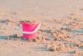 Pink plastic bucket full of sand for kid summer vacation toy concept Royalty Free Stock Photo