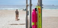 Colorful pink rescue buoy attached to a light green sign.