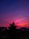 Pink , red sky just before dawn .