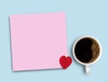 Colorful pink sticky note,red heart and cup of coffee on blue table background Royalty Free Stock Photo