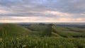 colorful pink sunset over green hills