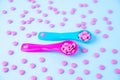 Colorful pink tablets in colored plastic round spoons. Blisters of pills in the background. Concept of medicine Royalty Free Stock Photo