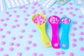 Colorful pink tablets in colored plastic round spoons. Blisters of pills in the background. Concept of medicine Royalty Free Stock Photo