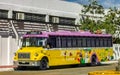 Colorful pink yellow green Xcaret bus Playa del Carmen Mexico