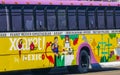 Colorful pink yellow green Xcaret bus Playa del Carmen Mexico