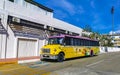 Colorful pink yellow green Xcaret bus Playa del Carmen Mexico