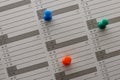 Colorful pins on the calendar. Royalty Free Stock Photo