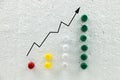 Colorful pins on polystyrene business growth chart.